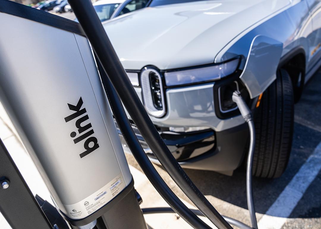 An EV charges from a Blink Charging station.