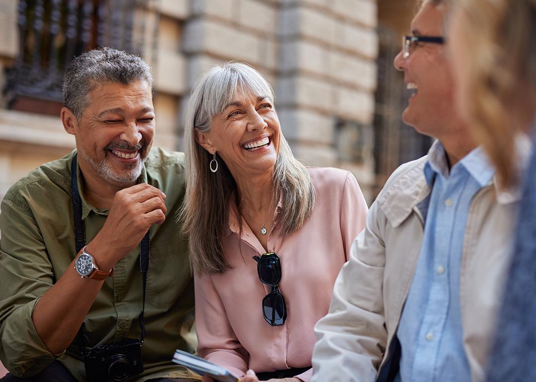 A group of senior friends laughing together on a day out.