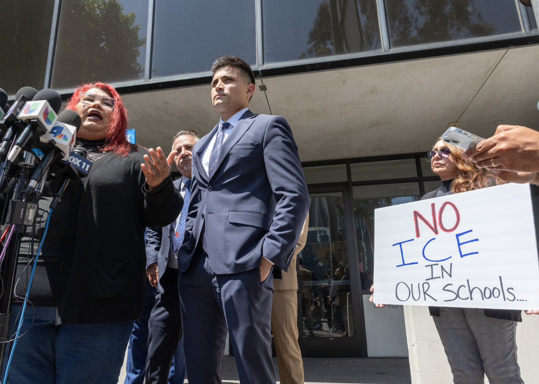 Andreina Mejia, mother of the Arleta High School student, a citizen, who was detained by immigration agents, speaks about their experience at a press conference announcing legal claims against the U.S. government. A few people stand beside her, including one woman holding a sign that reads, "No ICE in our schools."