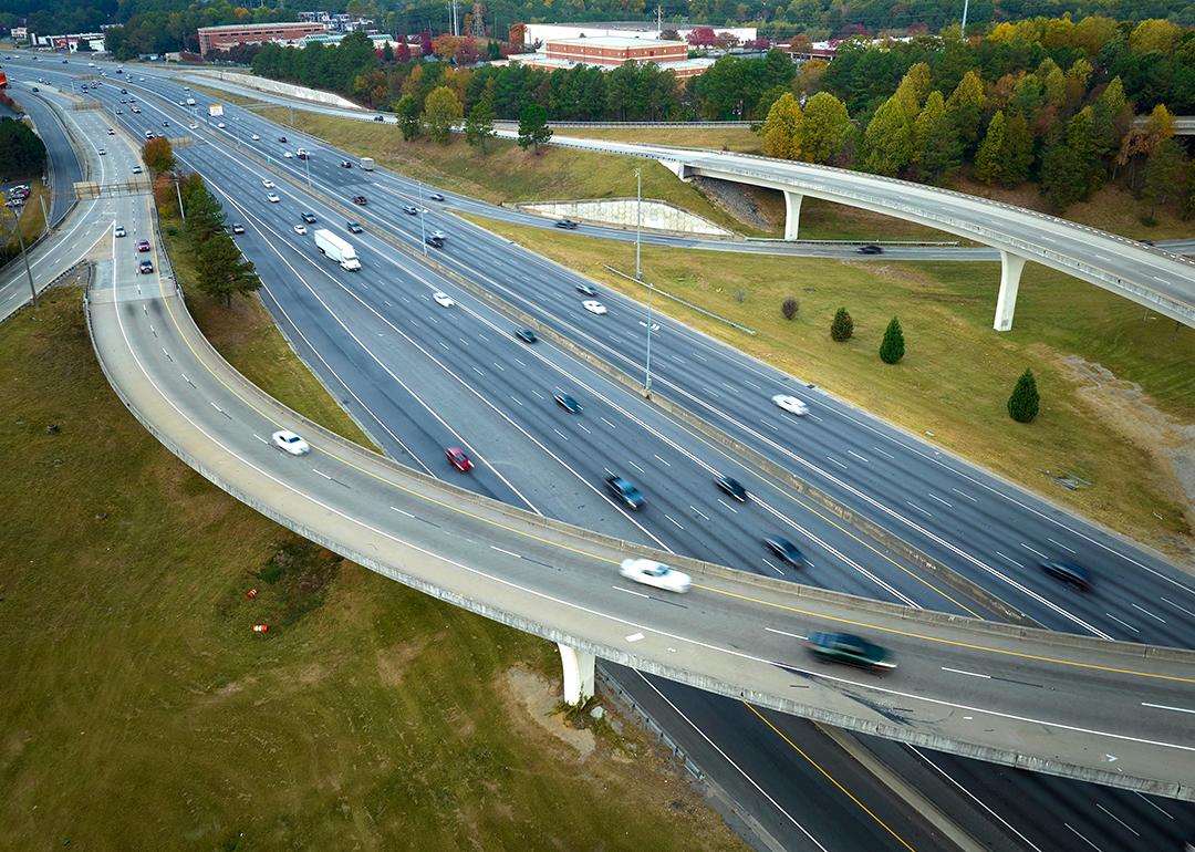 An aerial view of an American freeway intersection with fast moving trucks and cars.