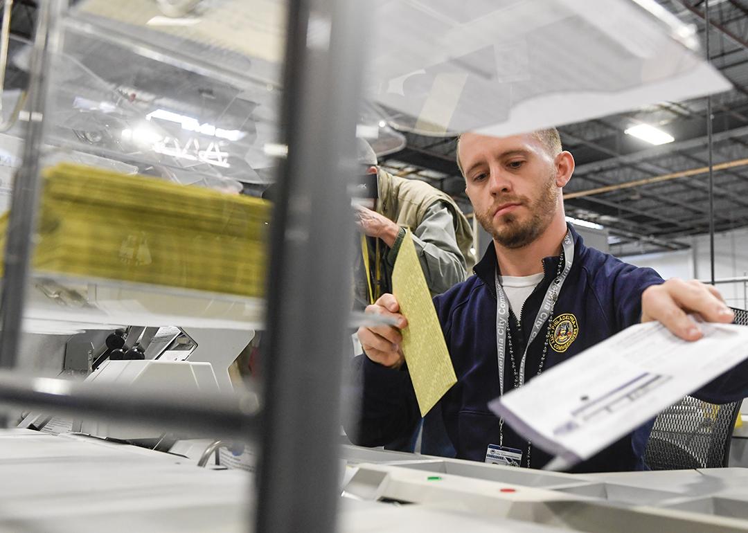 Poll workers demonstrate how ballots are received, processed, scanned, and securely stored on Election Day.