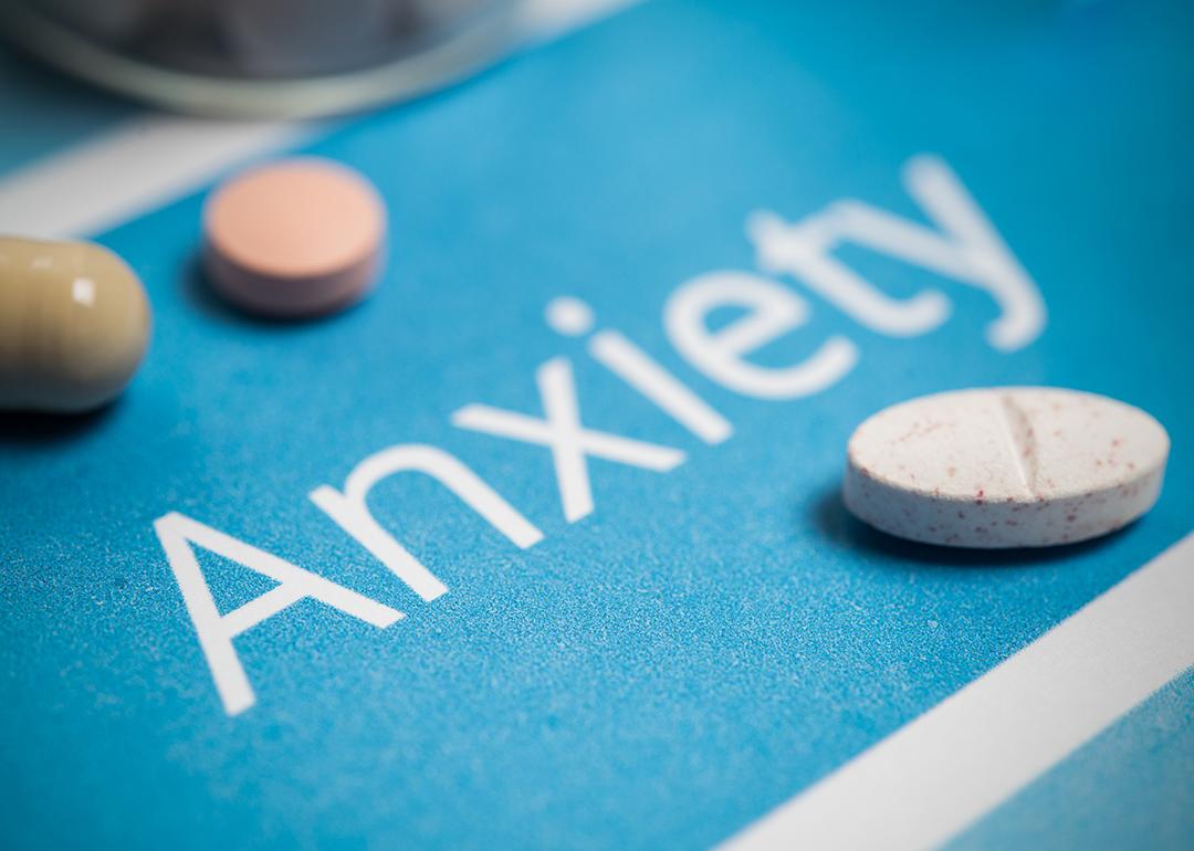 Medication and pills on top of a surface with the word 'anxiety'.