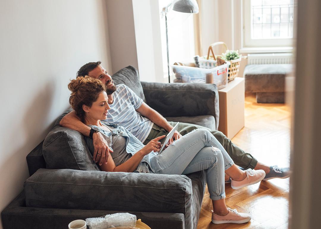 A couple sitting together on a sofa at home