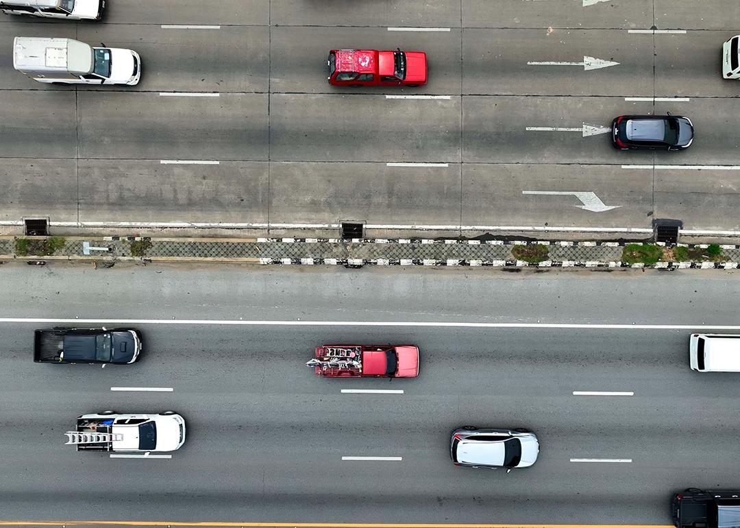 Aerial view of moving vehicles on a multi-lane highway.