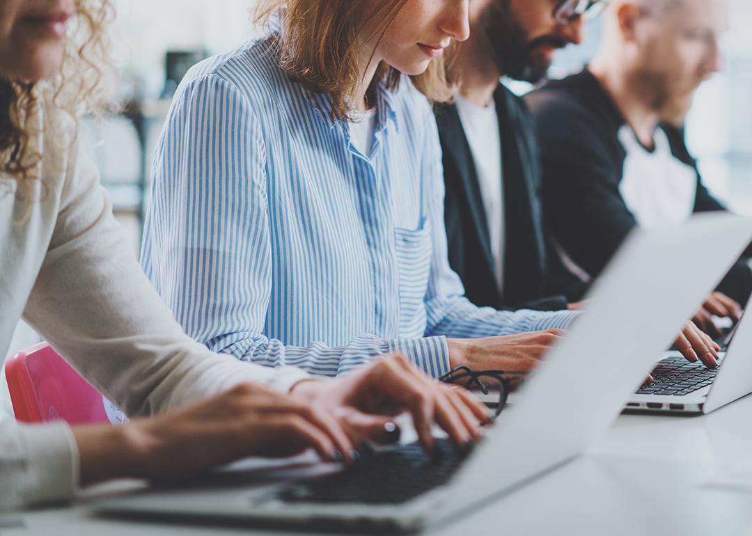 A row of employees working in an office.