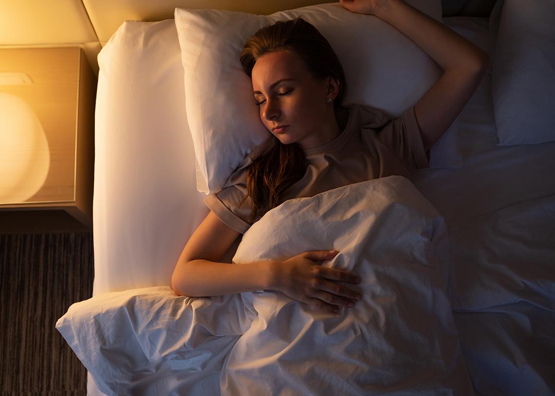 A young woman sleeping on her back.