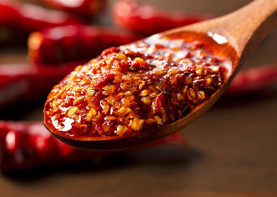 Chili oil scooped up with a wooden tablespoon.