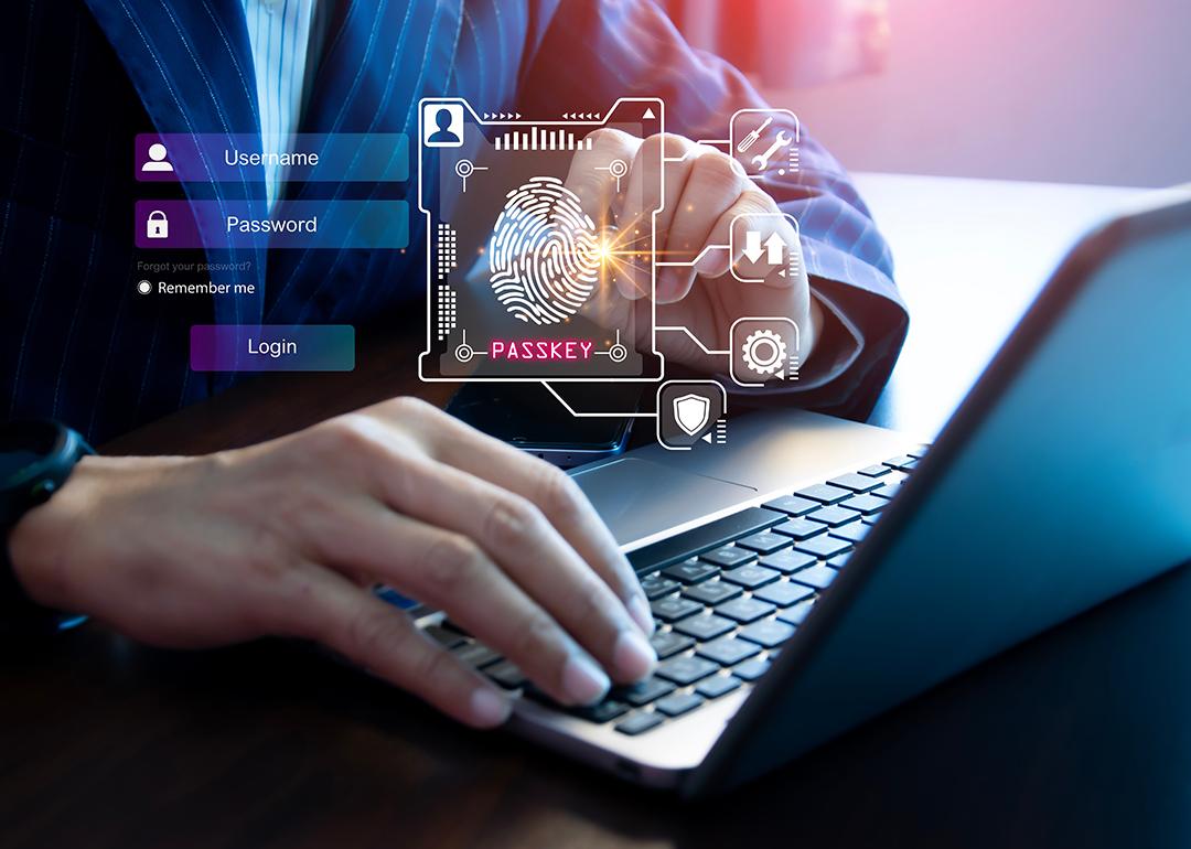 Person using a laptop illustrated with graphics of digital user login interface.