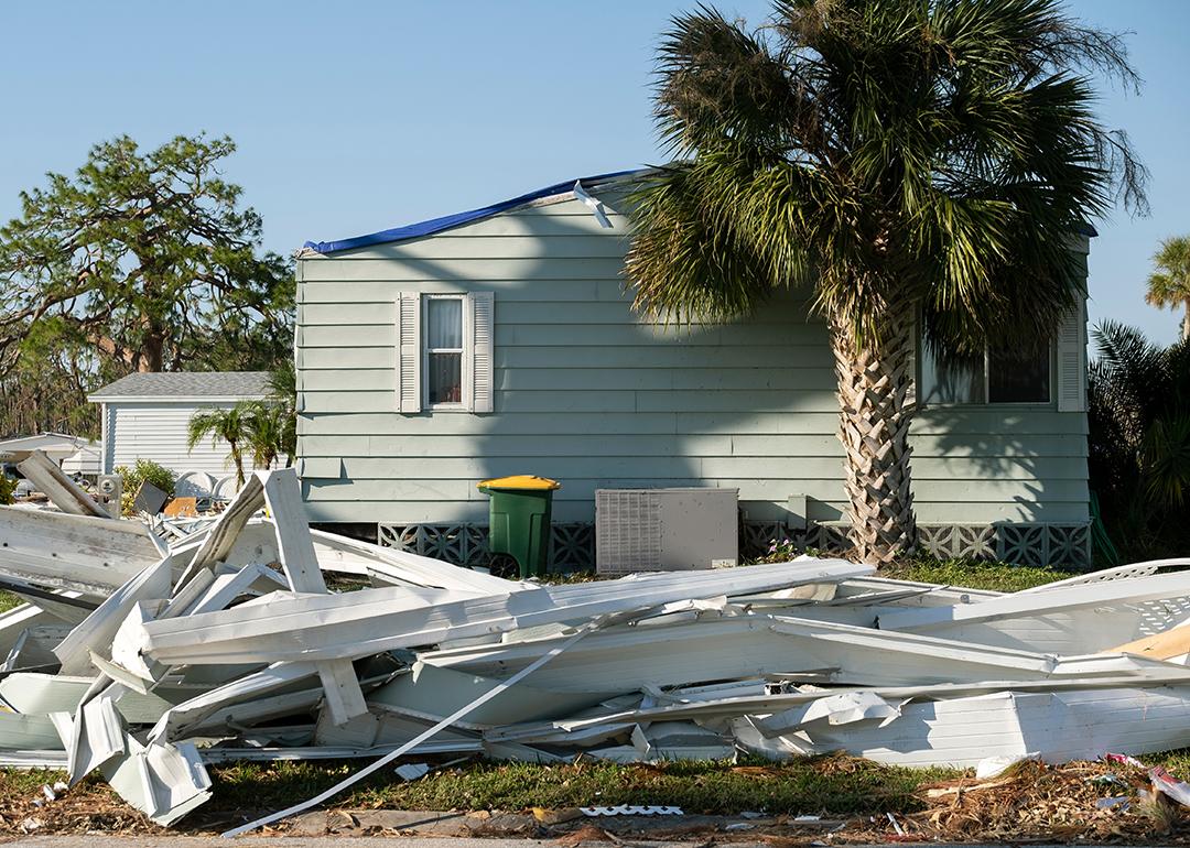 Debris on the side of a street after a hurricane in a residential area in Florida.