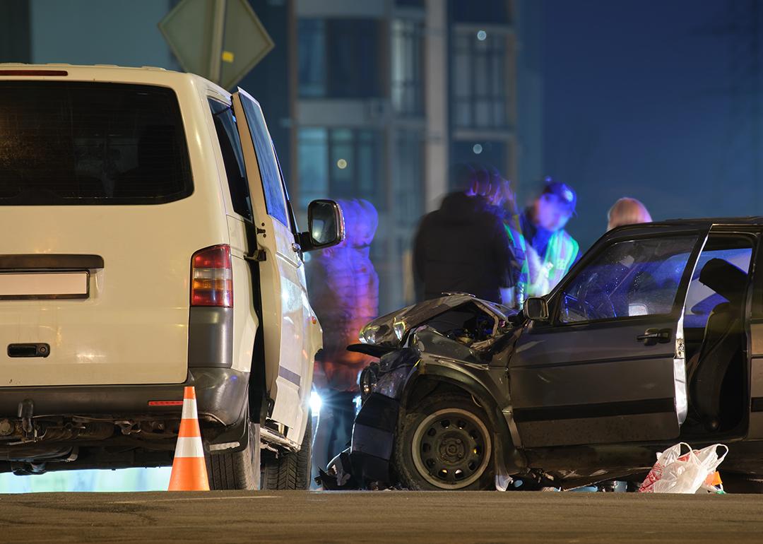 Cars crashed heavily in a road accident at night.