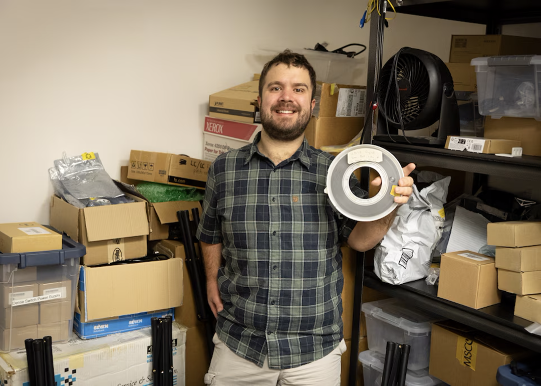 Aleks Maricq, a research associate at the University of Utah, holds the 9-track magnetic tape marked as containing a copy of UNIX Version 4, a foundational computer operating system, that he found in a storage room.