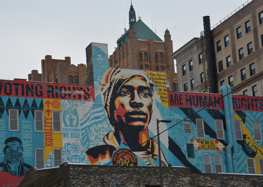 A Shepard Fairey-designed voting-rights mural rises over downtown Milwaukee, where voters and election officials remain under scrutiny for their election practices.