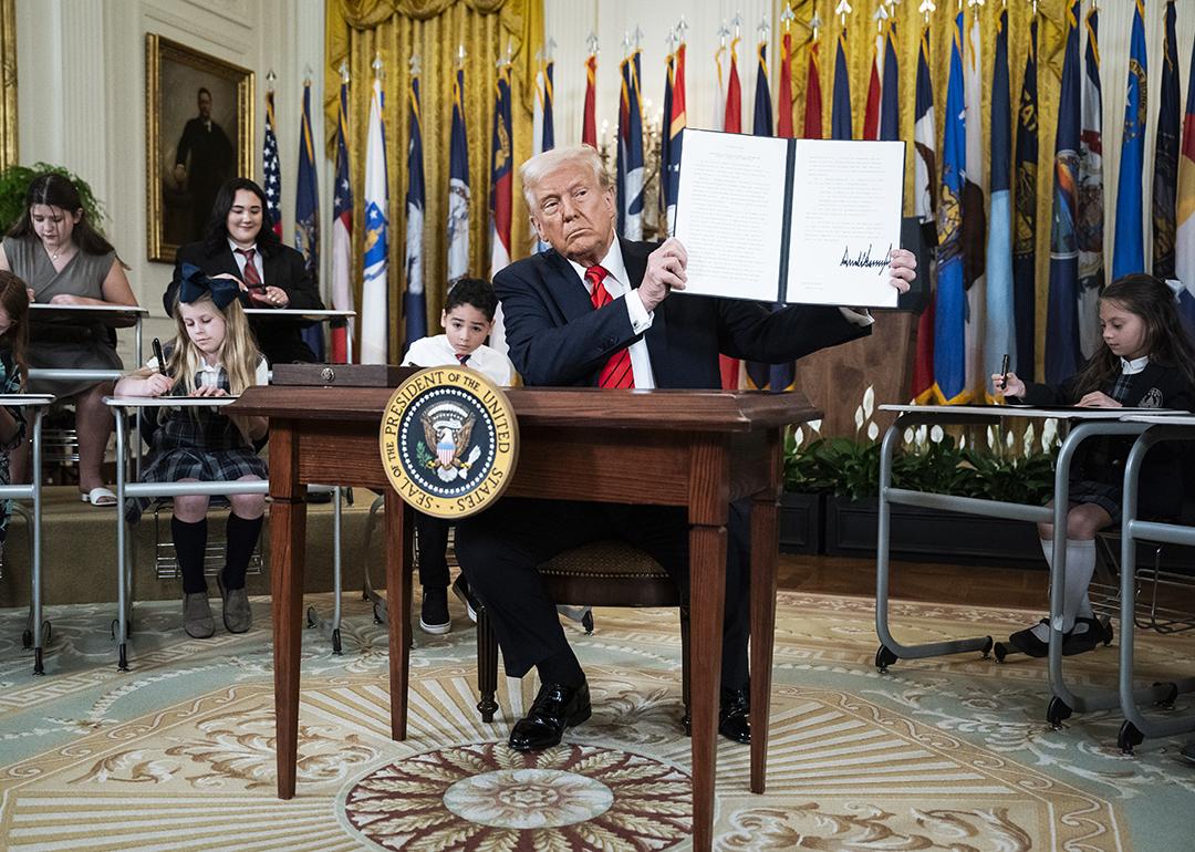 US President, Donald Trump, displaying a signed executive order aimed at closing the Education Department during an event at the White House on March 20, 2025 in Washington, D.C.