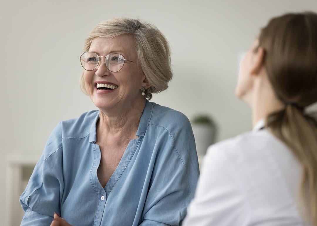 A senior woman laughing during clinic visit.