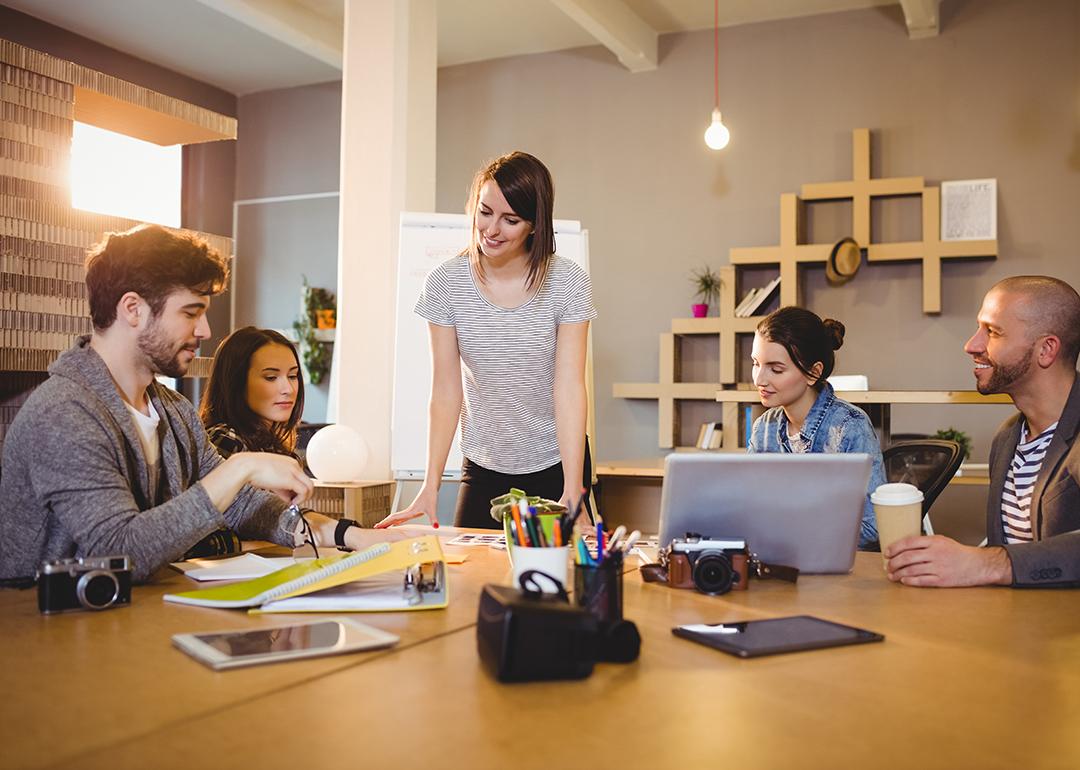 A graphic design team in a meeting room working on a project.