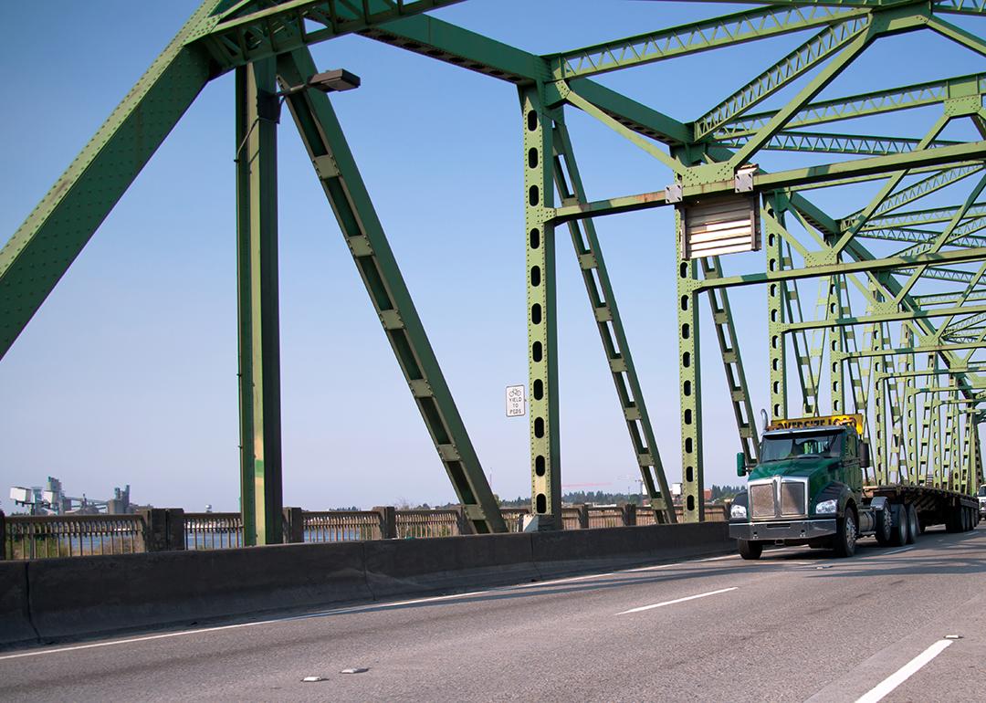 An empty transport semi truck going through a bridge.