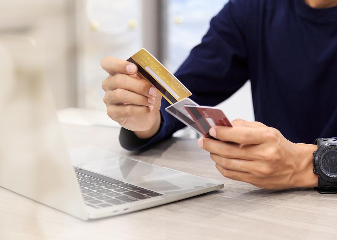 Man holding multiple credit cards.