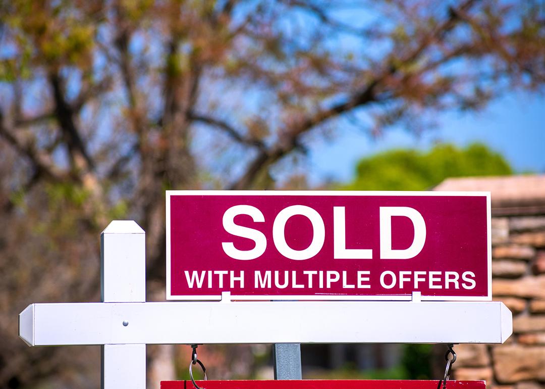 A 'sold with multiple offers' sign for a property.