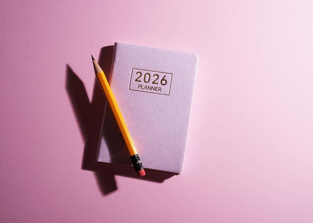 A pink 2026 planner with a pencil against a pink background.