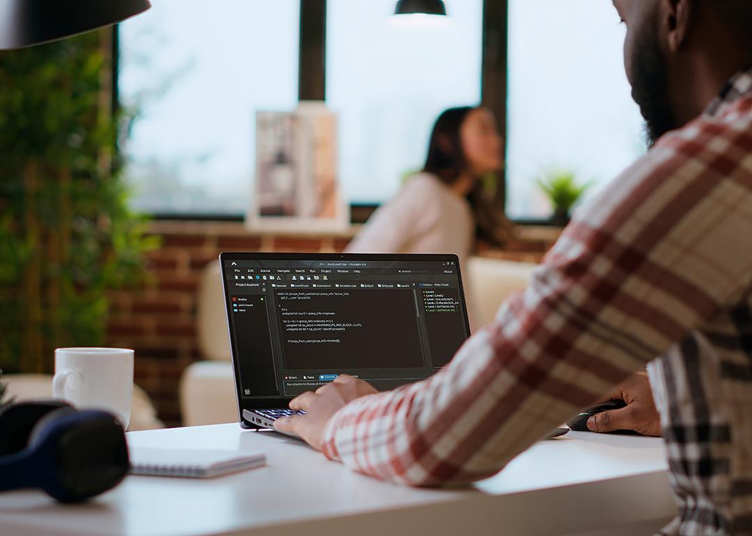 Software engineer working on coding a project.