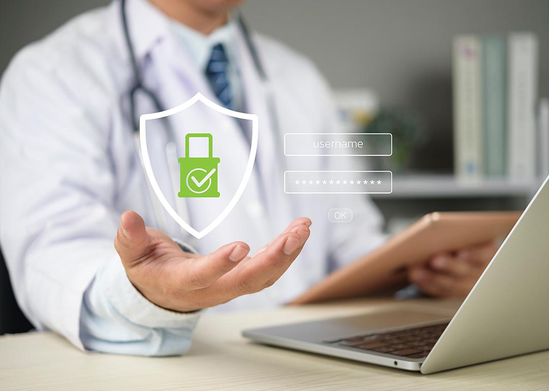 A doctor's hand holding up a graphic of medical data login as a concept of medical data security.