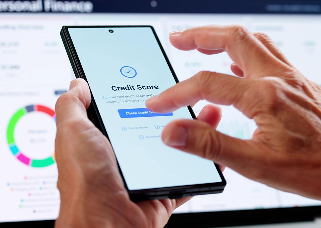Person checking credit score online using smartphone.