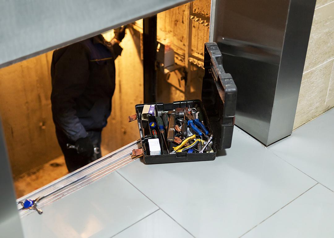 A specialist inside an elevator shaft to repair systems.