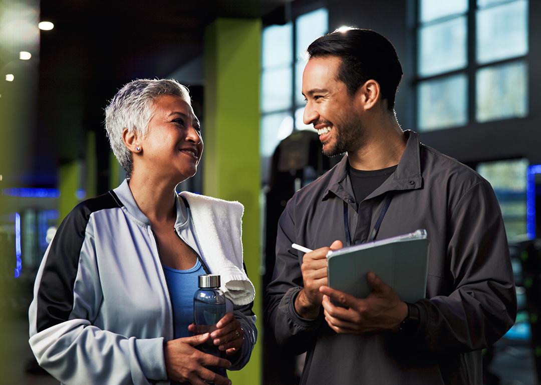 A middle aged woman with her gym trainer.
