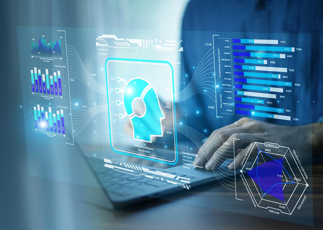 A businessman using AI-powered CRM technology on a laptop.