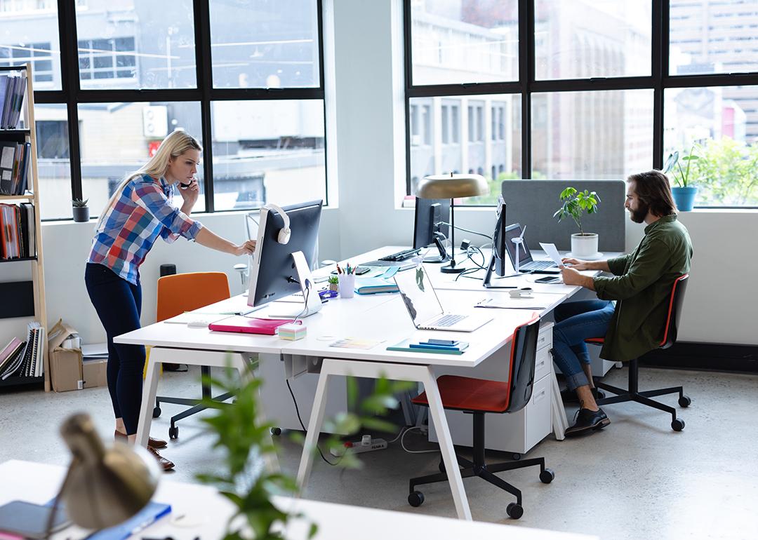Two businesspeople working in a creative office.