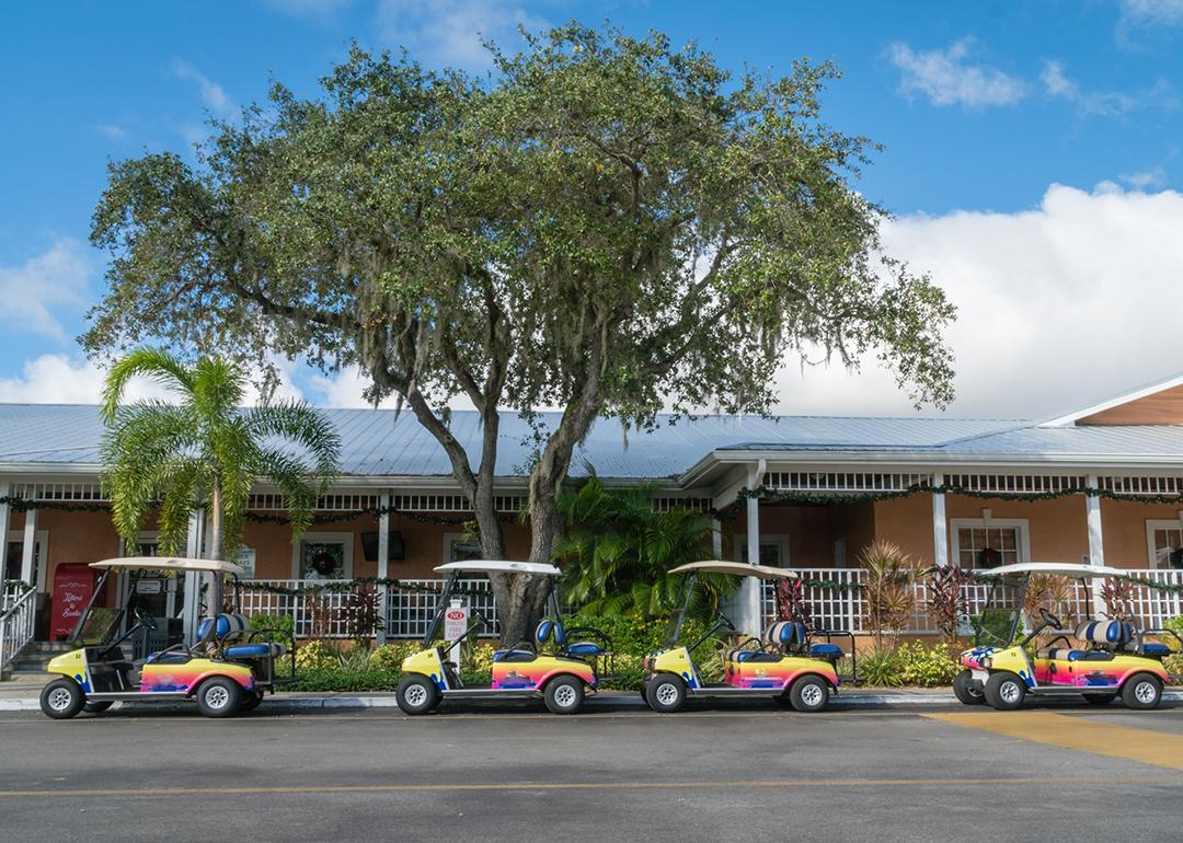 A row of colorful golf carts parked at an RV resort in Florida.
