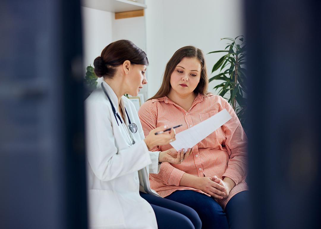 An plus-size young woman consulting with her doctor.