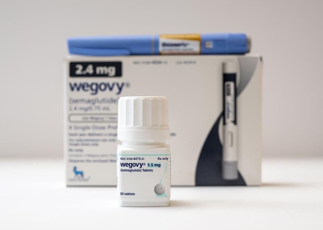 A bottle of Wegovy tablets its box and an Ozempic pen in the background.