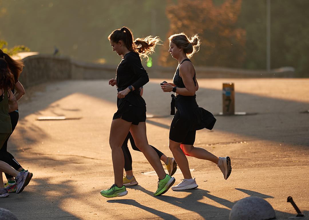 A group of women jogging outdoors.