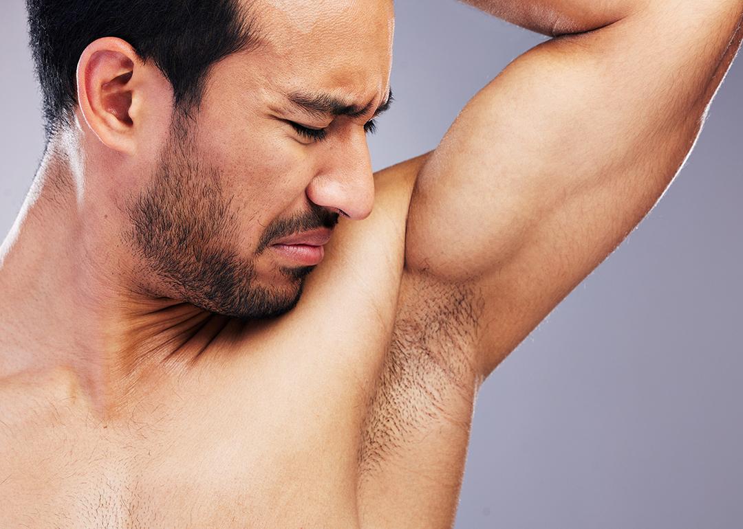 Man smelling his armpit.
