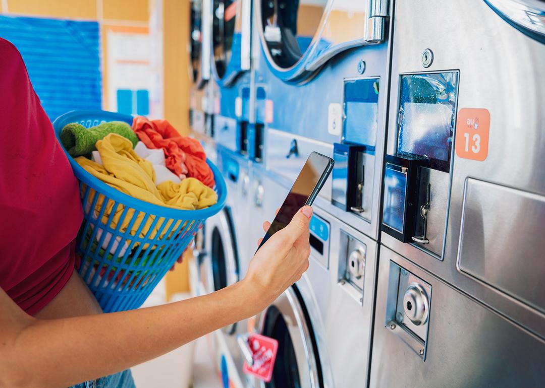A young woman paying for a laundromat using a mobile app.