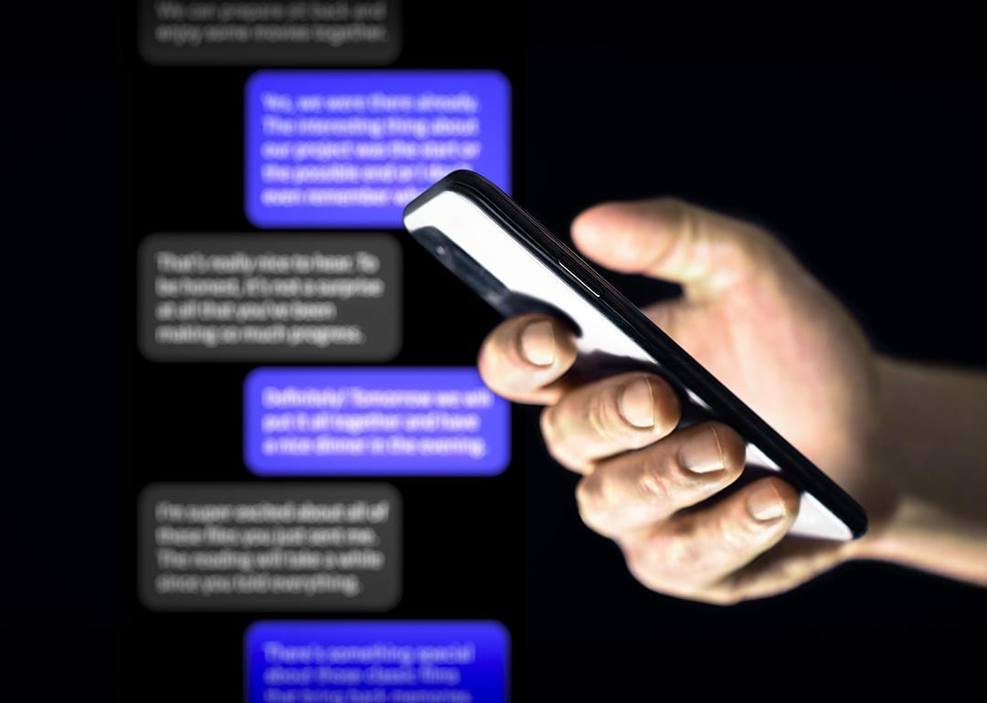 Person using a smartphone against a background of chat bubbles.
