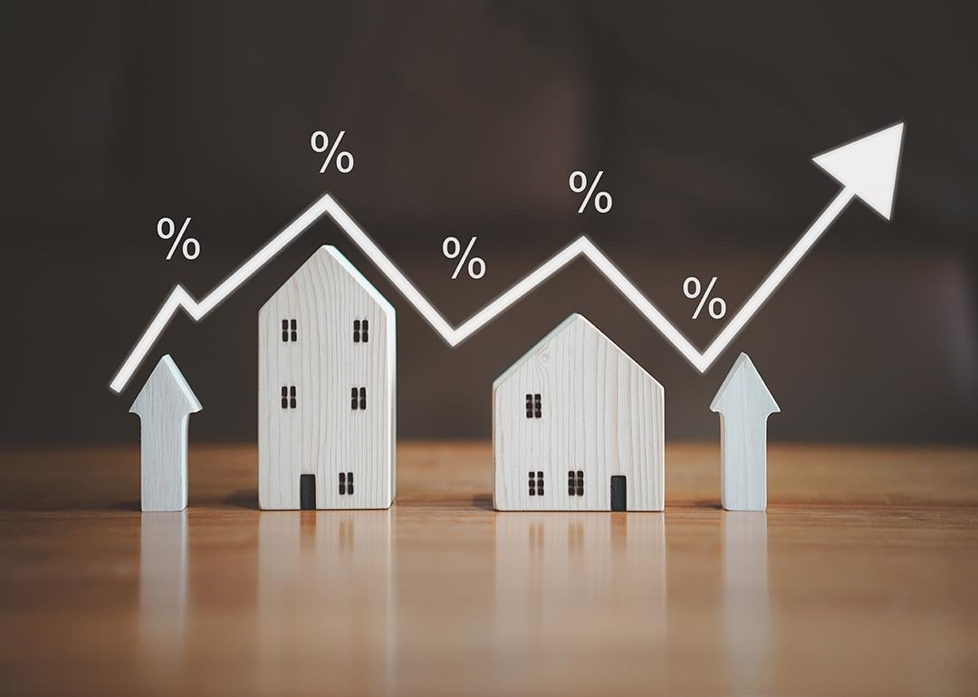 Small figures of houses and upward arrows illustrated with an increasing arrow and percentage rate graphics.
