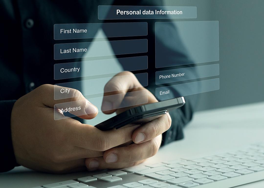 Person typing on smartphone illustrated with personal data sheet graphics.