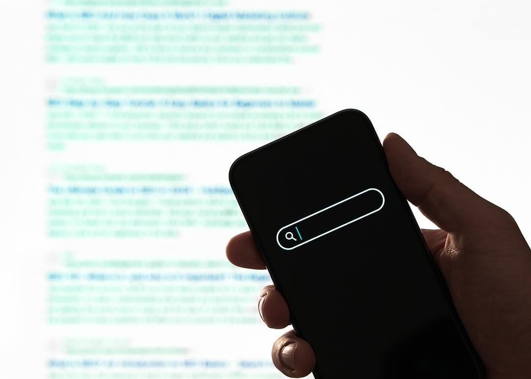 Search engine display on phone, against a background of paragraphs of information.