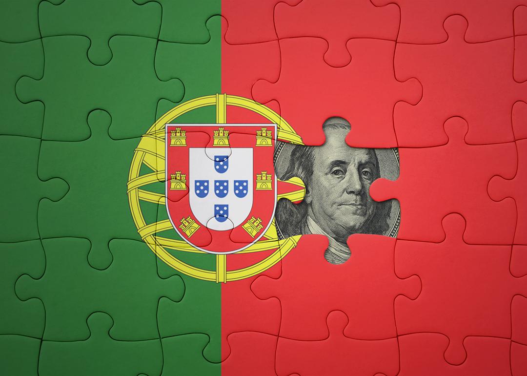 Flag of Portugal in puzzle pieces revealing a US dollar banknote.