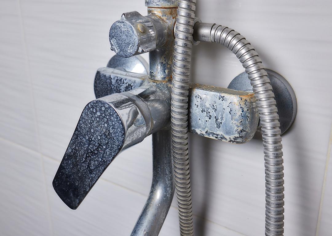 An old tap aerator with marks of hard water.