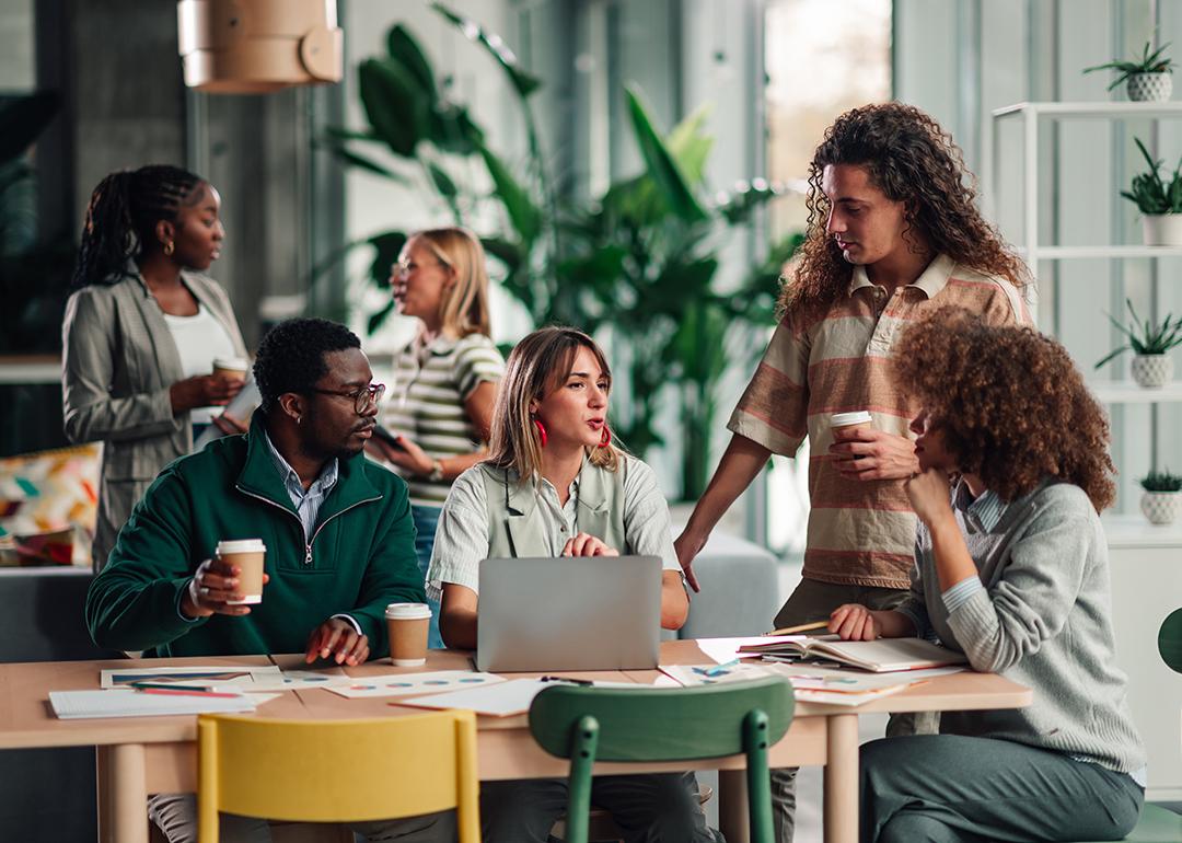 A diverse business team discussing a project in an office environment.