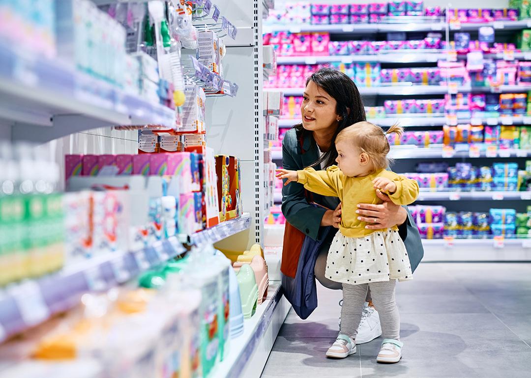 A mother and her young daughter shopping in a drugstore.