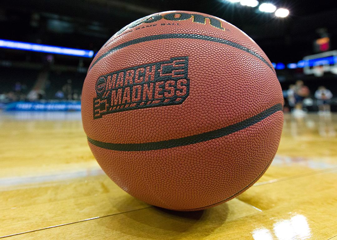 A game ball labeled with 'March Madness' on a basketball court.