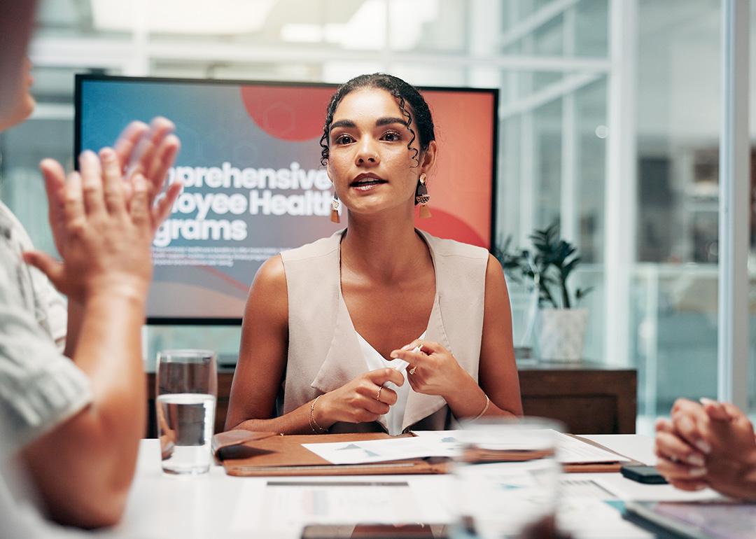 A businesswoman leading a boardroom meeting.