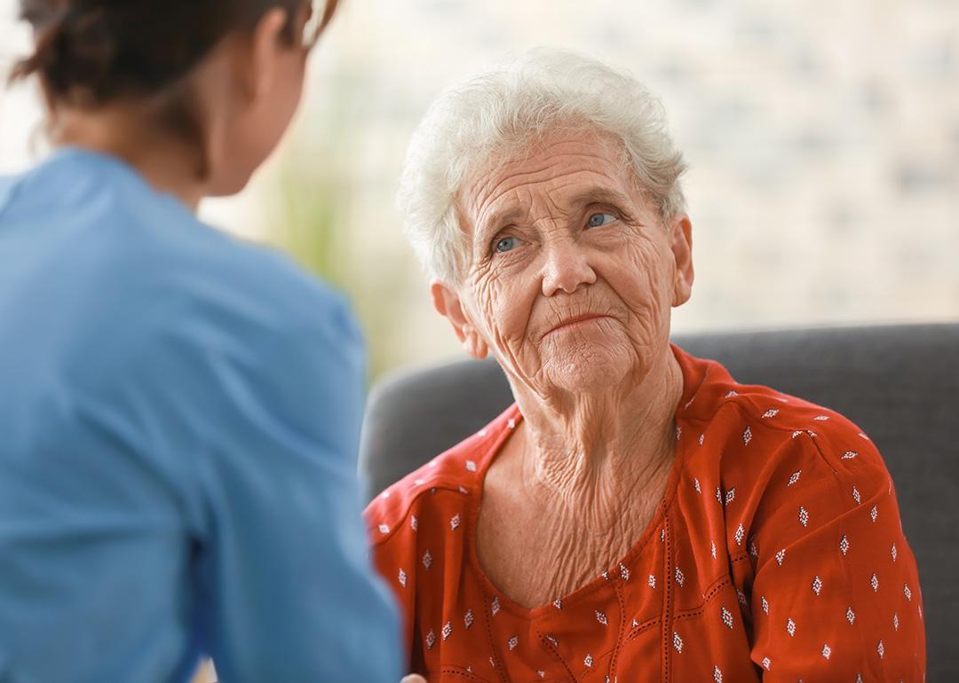 A senior woman facing her nurse.