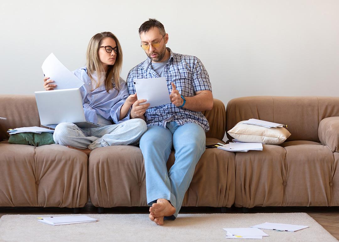 A couple reviewing documents at home.