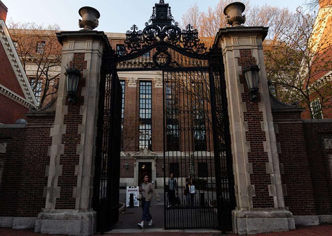 Students go in and out of the Harvard University gate.