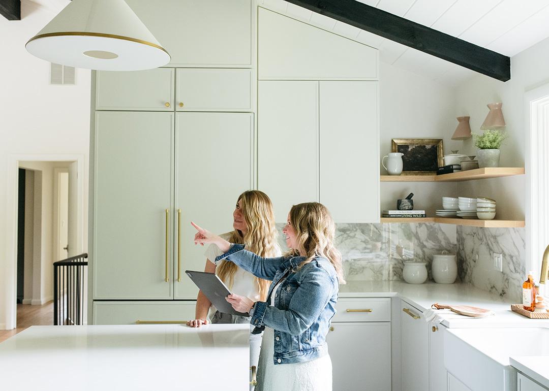 Two people checking out a design or structure in a kitchen.